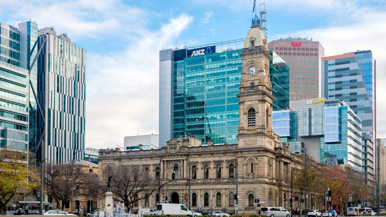 Adelaide: Victoria Square viewed from South to North with office buildings and traffic at morning time