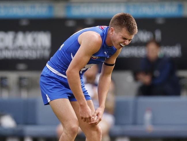 Colby McKercher of the Kangaroos in pain after collision with Jeremy Cameron of the Cats during the first quarter. Picture: Michael Klein