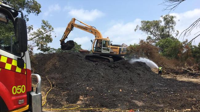 NSW Fire and Rescue help to flattened, spread and wet hazardous mulch to ensure it doesn’t start more fires. Picture: Cr Nathan Tilbury