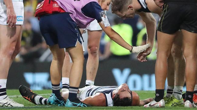 Geelong’s Sam Simpson is out cold after a big hit. Pic Peter Wallis