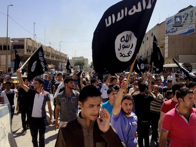 Demonstrators chant pro-Islamic State slogans in front of the provincial government headquarters in Mosul, northwest of Baghdad, Iraq. Picture: AP Photo