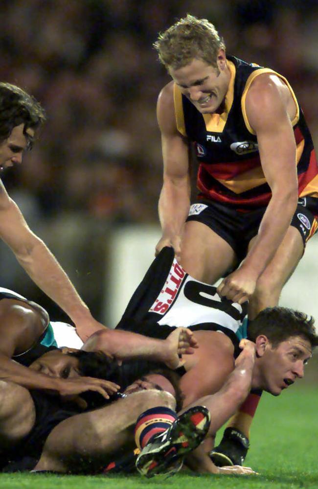 Ricciuto on the bottom of a pack with Josh Carr (right) in the 2002 Showdown at Footy Park.