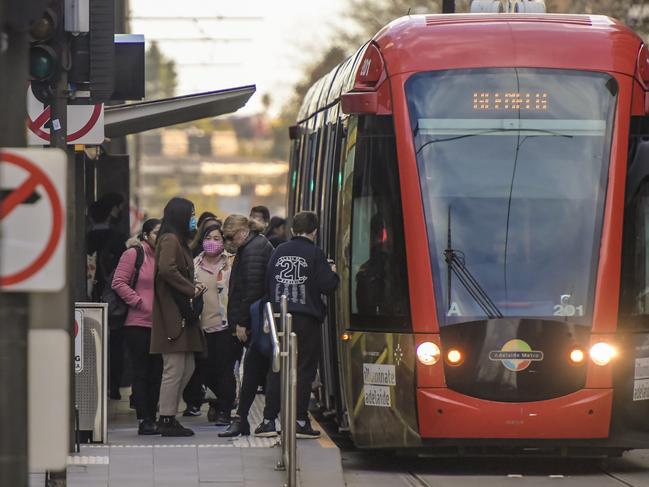 Mask Wearers Public Transport.Some people are seen wearing masks at the tram stop at KingWilliam st.  JUNE 29 2021. Picture Roy VanDerVegt