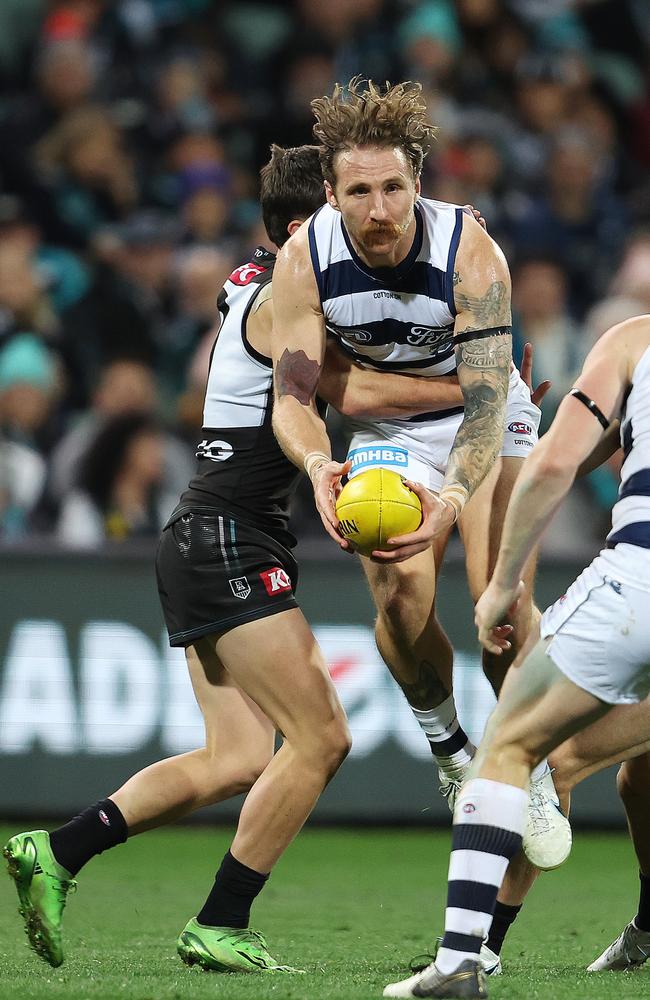 Zach Tuohy gets held up in a tackle. Picture: Sarah Reed/AFL Photos via Getty Images