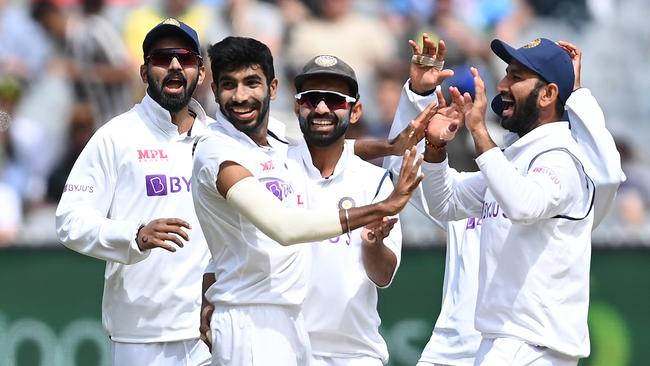 Jasprit Bumrah celebrates the wicket of Steve Smith with his teammates