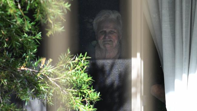 Patricia Shea, 76, looks out from her bedroom window to the perimeter fence to see her son Anthony Bowe at Anglicare’s Newmarch House on Wednesday. Picture: AAP