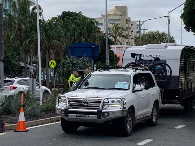 Police turn around a caravan at the border shortly before noon. Picture: Greg Stolz