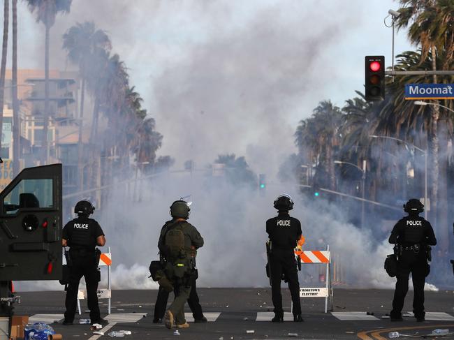 Police watch as tear gas is deployed during demonstrations in Santa Monica, California. Picture: AFP