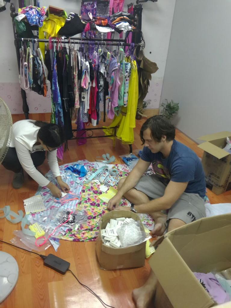 Alex Babich and a worker sorts through a pile of patterned materials.