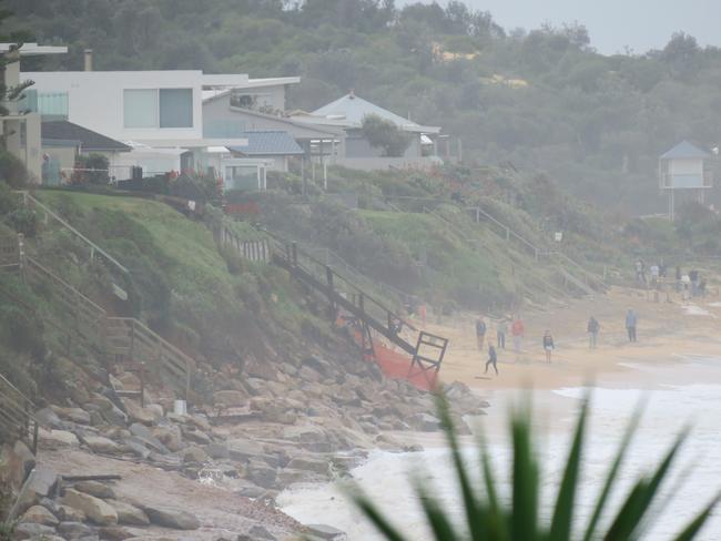 The massive erosion problem at Wamberal Beach is attracting hundreds of onlookers. Picture: Richard Noone