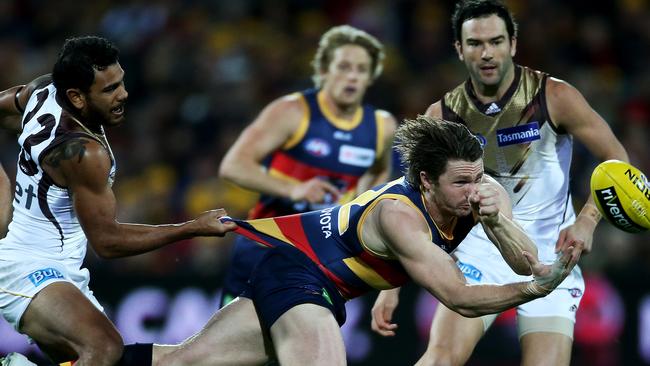 Powerhouse ... Patrick Dangerfield gets his handpass away, despite the efforts of Hawthorn’s Cyril Rioli. Picture: Simon Cross