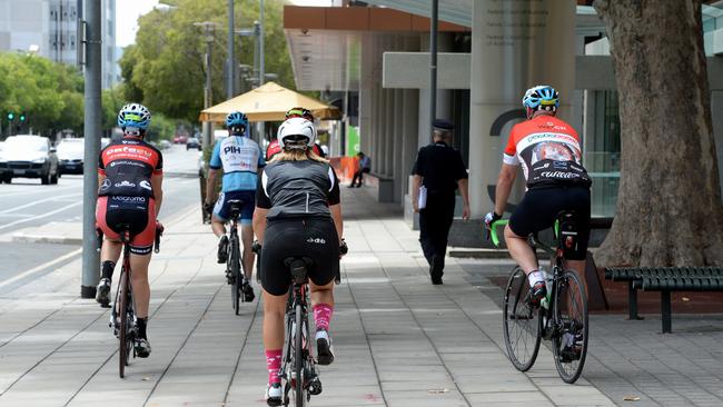 Cyclist using the footpath around Adelaide CBD.