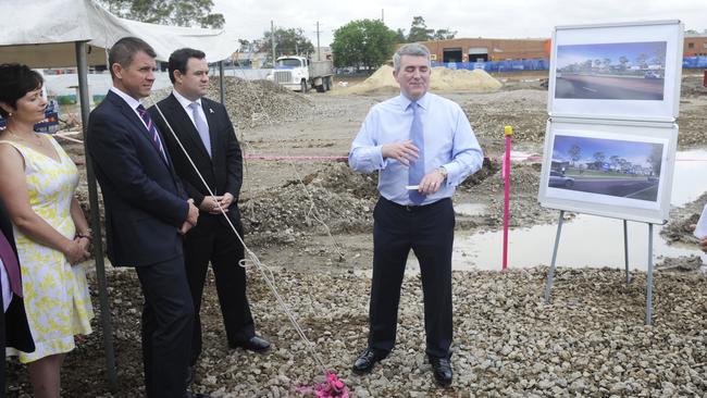 Matt Tyson, centre, with NSW Premier Mike Baird, turns the first sod at a Masters store in Sydney in 2014.