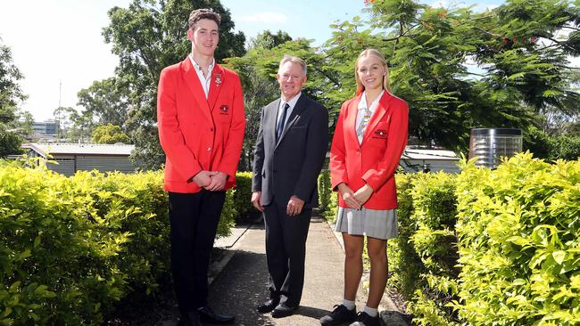 Benowa State High School has topped the state with their OP results. Principal Mark Rickard with school captains Matthew Coombes and Jemma Davey. Photo: AAP/Richard Gosling