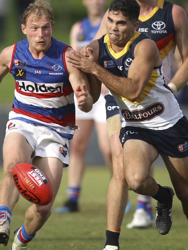 Tyson Stengle in action for the Crows at SANFL level puts pressure on Central District’s Travis Schiller in June. Picture: AAP Image/Dean Martin