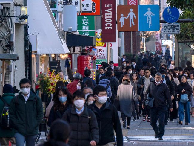 People make their way along a sidewalk in Tokyo. Picture: Kazuhiro Nogi/AFP