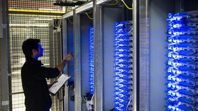 Cloud services are key to a future permanent remote work effort. An employee checks servers in a data centre. Picture: AFP