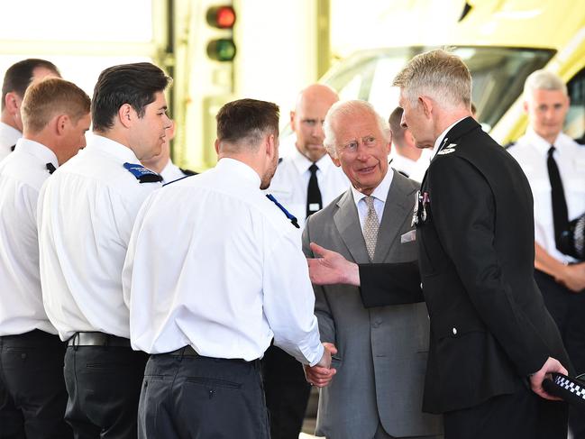 The King also met with members of the local fire brigade. Picture: AFP