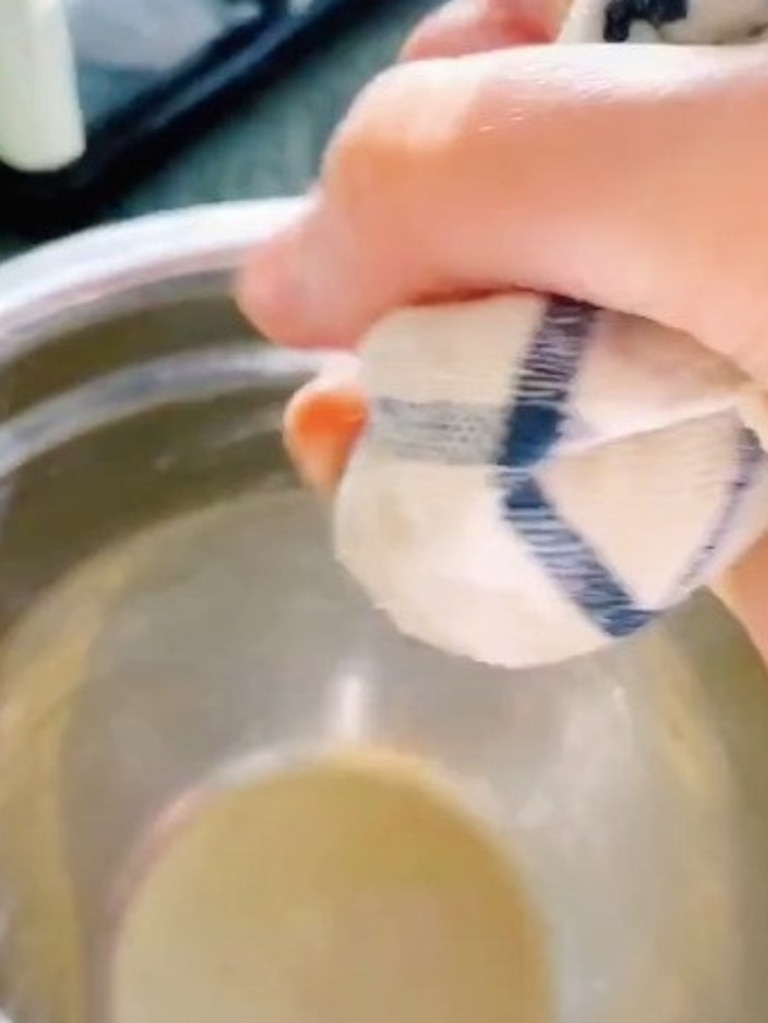 Next, transfer it to a clean cloth and wring out all the water from the potato. Picture: TokTok / Poppy Cooks