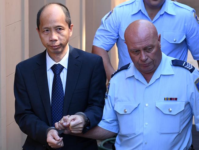 Robert Xie is escorted to a prison transport vehicle after his sentencing yesterday. Picture: AAP