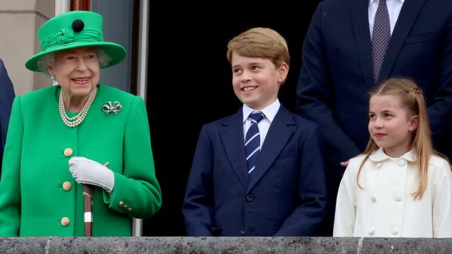 Queen Elizabeth II, Prince George of Cambridge and Princess Charlotte of Cambridge stand at Buckingham Palace in June. Picture: Getty Images