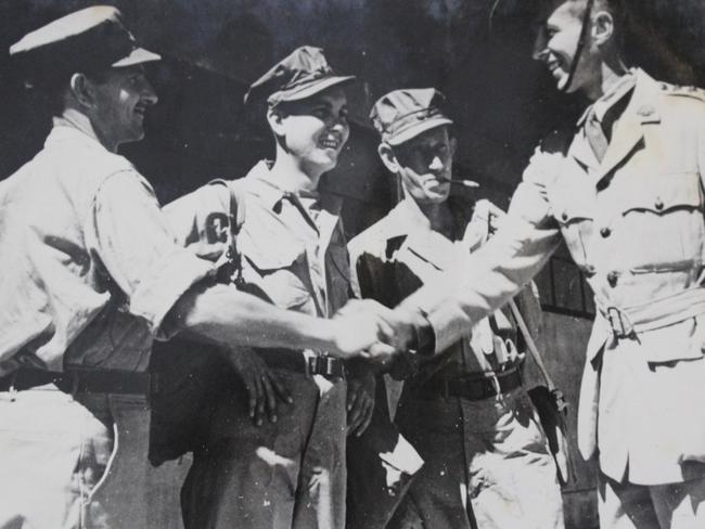 Wal Williams (hand on hips) and mates are reunited with their former commanding officer in Singapore after liberation from the Japanese labour camps. Picture: Supplied