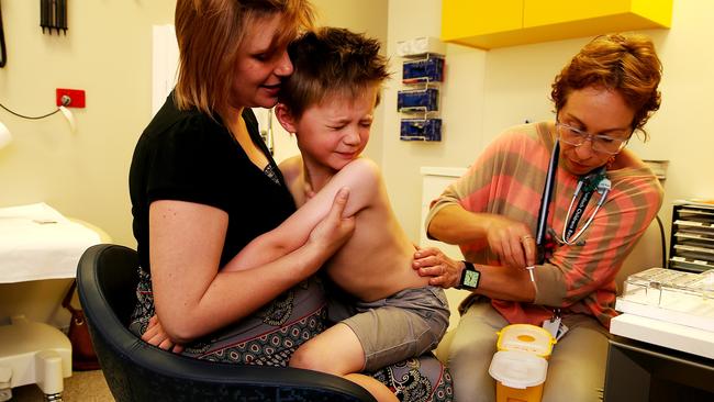 Cooper holds on to his mum while the skin prick samples are put on his skin by research nurse. Pictures Tim Carrafa