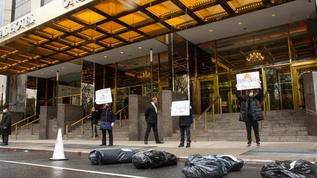 Protesters stand over fake body bags in front of the Trump International Hotel in New York. Picture: AFP.