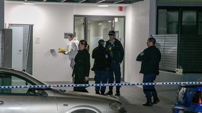 Forensic officers gather at front of the apartments. Picture: Damian Hoffman