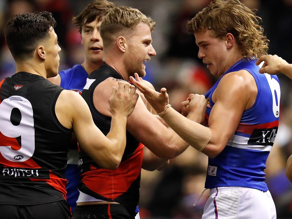 MELBOURNE, AUSTRALIA - AUGUST 10: Jake Stringer of the Bombers and Bailey Smith of the Bulldogs exchange words during the 2019 AFL round 21 match between the Essendon Bombers and the Western Bulldogs at Marvel Stadium on August 10, 2019 in Melbourne, Australia. (Photo by Michael Willson/AFL Photos via Getty Images)