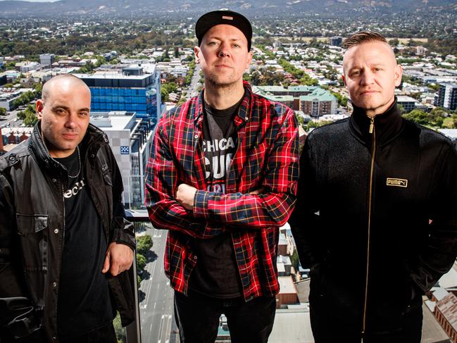 EMBARGO - DO NOT USE WITHOUT SPEAKING TO THE TISER PIC DESK - 5/11/2019 The Hilltop Hoods: Baz Francis (DJ Debris), Matt Lambert (MC Suffa) and Dan Smith (MC Pressure) above the rooftops of Adelaide. Picture MATT TURNER.