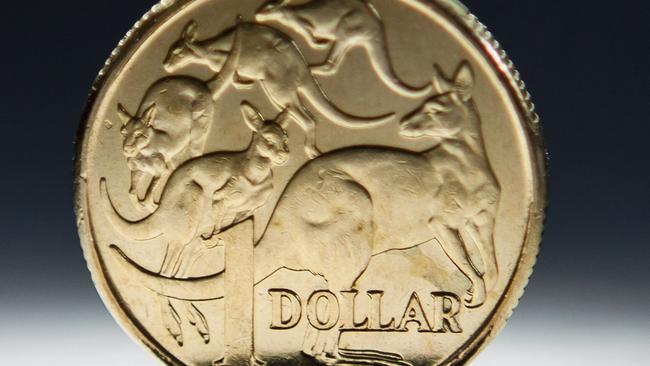 An Australian one-dollar coin is arranged for a photograph in Sydney, Australia, on Wednesday, April 17, 2013. Direct trading between the Australian dollar and yuan started on April 10. Photographer: Ian Waldie/Bloomberg