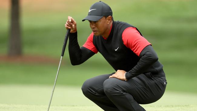 Tiger Woods of the United States lines up a putt.