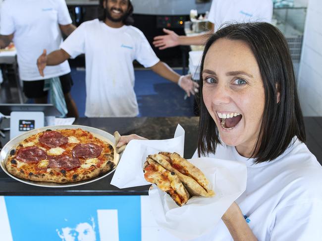 Roma Driscoll holds a Margherita Pizza Portfolio (A Fold up pizza) and The Goomah pizza at newly opened Francesca's at Glenelg with co-owners Aman Takher,Nilavan Baskaran and Aiden O'Sullivan .Wednesday,March,6,2024.Picture Mark Brake