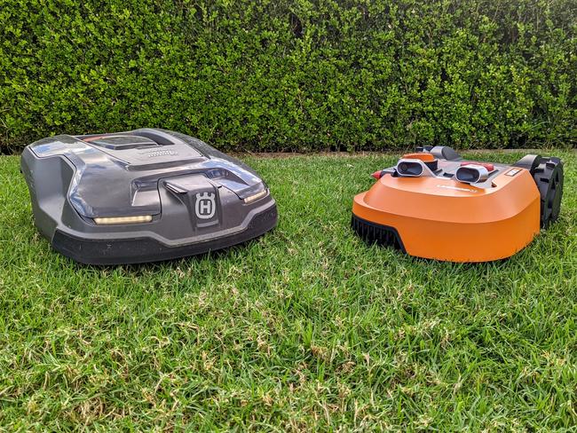 Out with the blades! Husqvarna (grey) and Worx (orange) autonomous robot mowers go head-to-head.