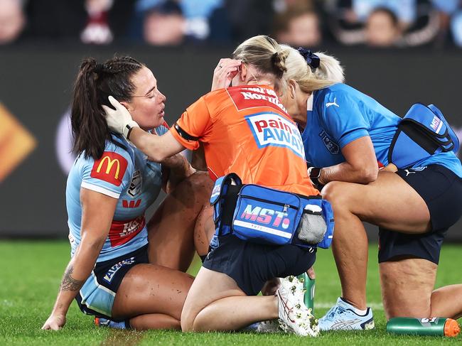 SYDNEY, AUSTRALIA - JUNE 01:  Isabelle Kelly of the Blues is assisted on the field after sustaining an injury during game one of the Women's State of Origin series between New South Wales and Queensland at CommBank Stadium on June 01, 2023 in Sydney, Australia. (Photo by Matt King/Getty Images)