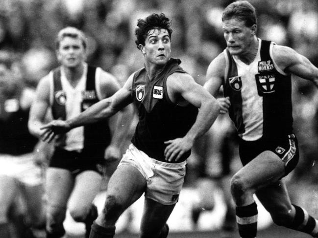 Burke chasing former Demon and current Western Bulldogs coach Luke Beveridge back in 1991, Burke went on to play 323 games.