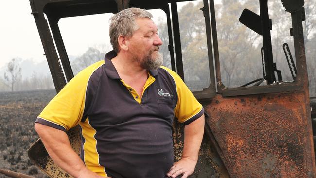 Rainbow Flat's farmer Garry May with his burnt out Fiat 550 and brand new slasher. Picture: Peter Lorimer.