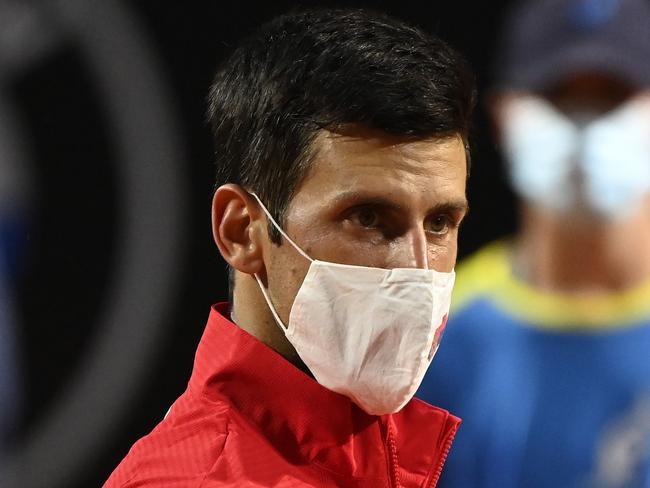 ROME, ITALY - SEPTEMBER 21: Novak Djokovic of Serbia looks on wearing a mask in the presentation ceremony after winning his men's final match against Diego Schwartzman of Argentina during day eight of the Internazionali BNL d'Italia at Foro Italico on September 21, 2020 in Rome, Italy. (Photo by Riccardo Antimiani - Pool/Getty Images)