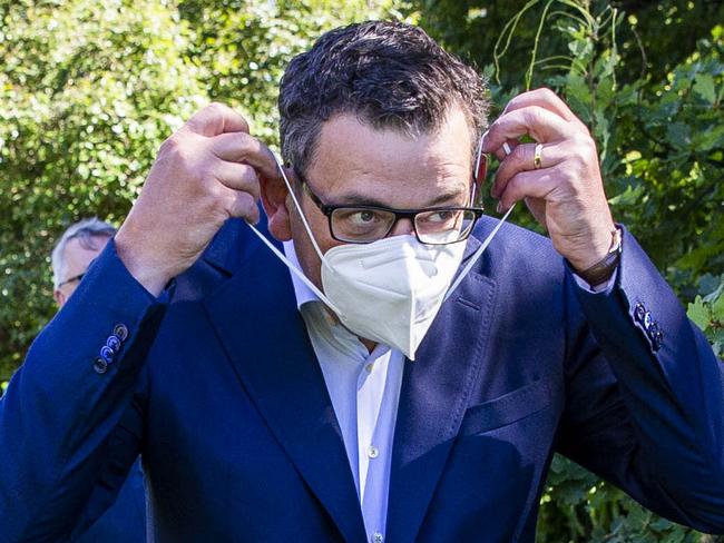 MELBOURNE, AUSTRALIA - NewsWire Photos February 17, 2022: (L-R) Victorian Premier Daniel Andrews puts on a mask after a press conference at Parliament. Picture: NCA NewsWire / Aaron Francis