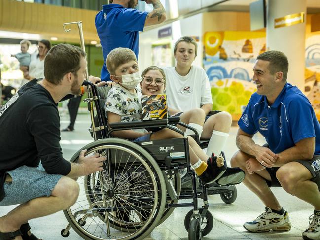 The Roos stars brought presents for the patients, donated by toy brand Mattel. Picture: Jake Nowakowski