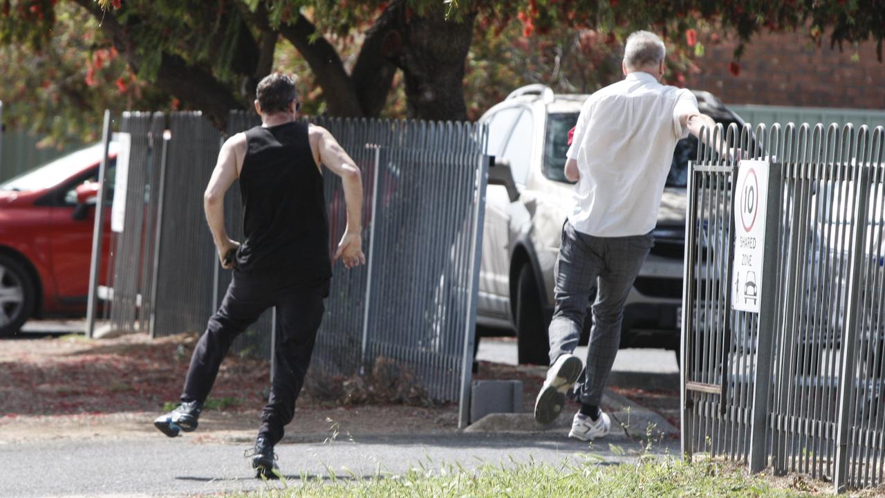 The ex-councillor flees Christies Beach Magistrates Court, yelled at by the man. Picture: Brett Hartwig