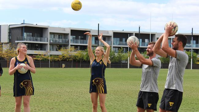 Hawks Netball’s Nat Billings and Monique Tarrant put Hawthorn’s Jack Gunston and Brendan Whitecross through their paces.