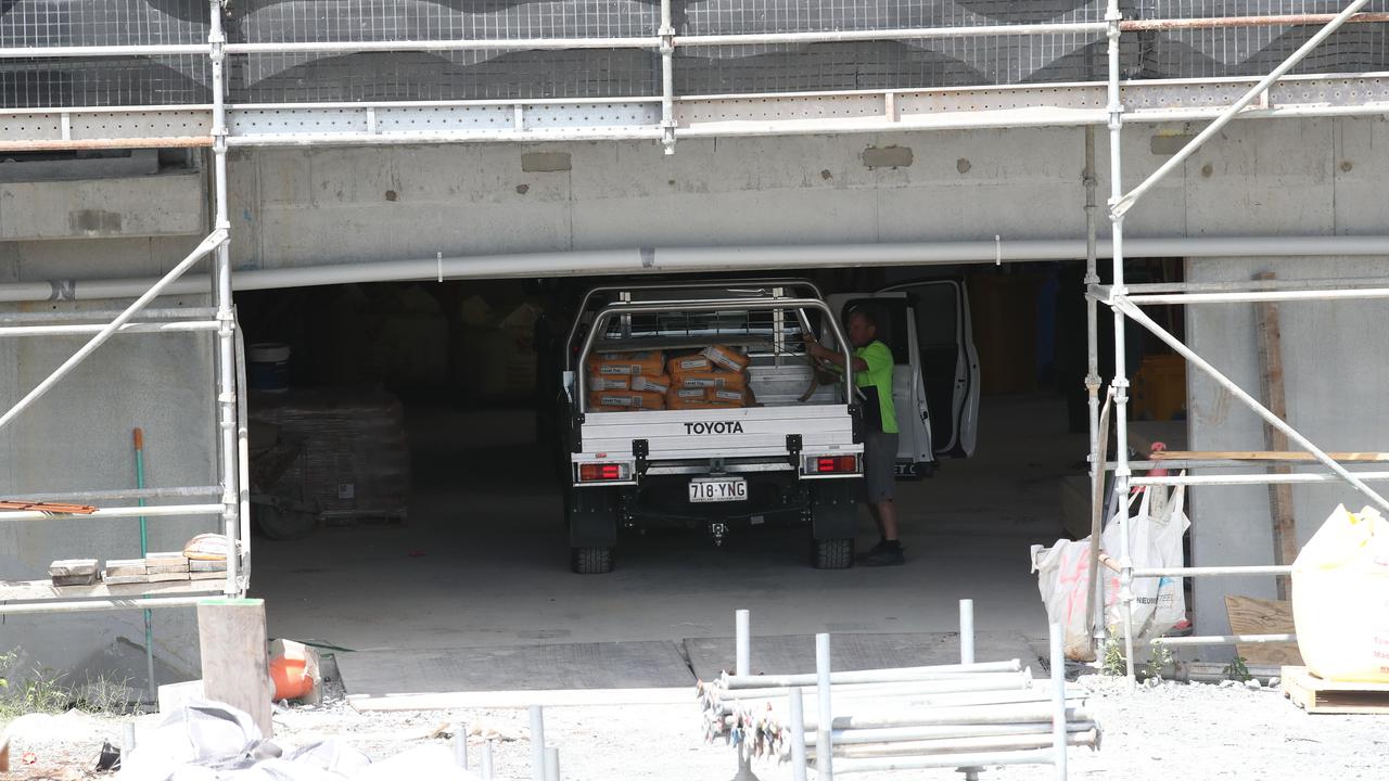 Workers loading up utes with goods at Brooke Residences at Robina earlier in the week. Picture: Glenn Hampson