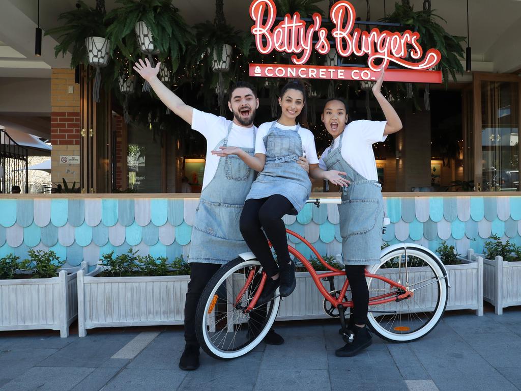 Ryland Joyce, Annalise Sergi and Ysabella Nieves pose for a photo at Betty's Burgers today, August 4, 2018. Betty's Burgers and Concrete Co. held its grand opening in Castle Towers Piazza today. (AAP Image/David Swift)