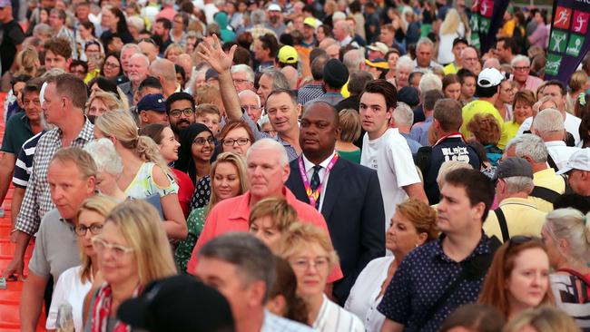 Crowds wait for buses to the opening ceremony. Photo by Richard Gosling