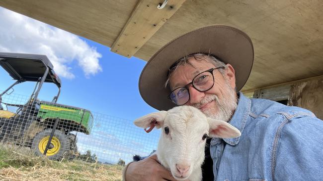 Alex Cramb, former media spinner to Anthony Albanese, with his poddy lamb, Little Bob. Picture: Supplied.