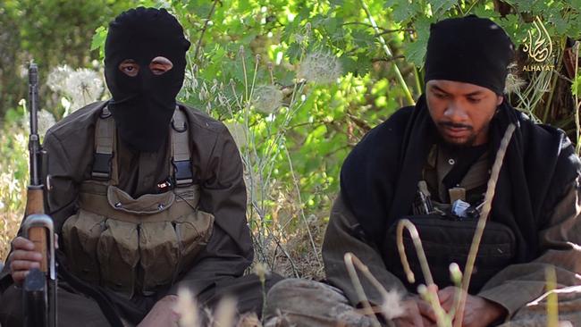 Abu Khaled (aka Neil Prakash, right) sits alongside fellow Australian Islamic State fighter Abu Nour al Iraq in a propaganda video released by the group in mid-2014.