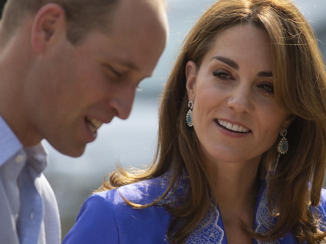 Wearing a traditional Pakistani dress called a Kurta, Britain's Princess Kate speaks to Prince William during her visit with teachers in a suburb of Islamabad, Pakistan, Tuesday, Oct. 15, 2019. The Duke and Duchess of Cambridge, who are strong advocates of girls' education were greeted by teachers and children. (AP Photo/B.K. Bangash)