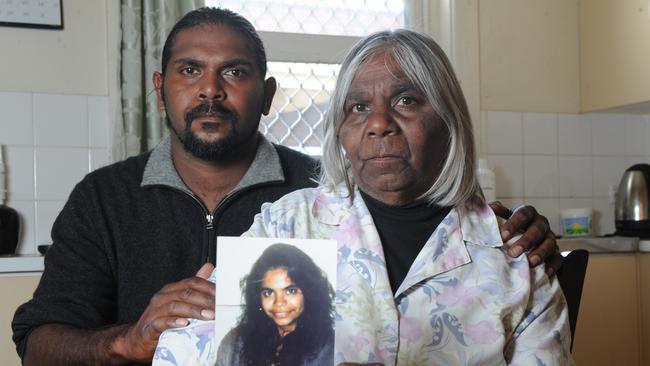 Kim Williams and his mother Eva Williams with pictures of Karen who disappeared from Coober Pedy 22 years ago.